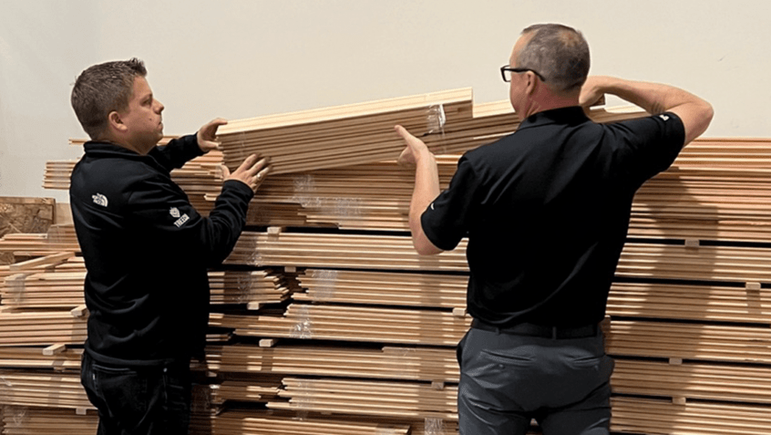 Timeless President Paul Phillips and Vancouver Branch Manager Brad Scott stacking wood flooring